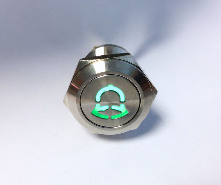 stamped bell icon on an antivandal push button switch, led button, rjs electronics ltd